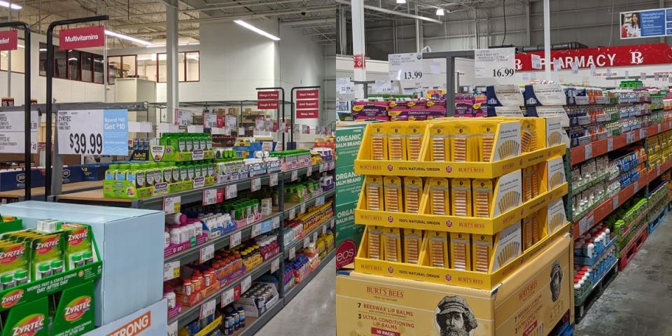 Boxes of supplements at BJ's and boxes of vitamins and Burt's Bee's lip balm display at Costco