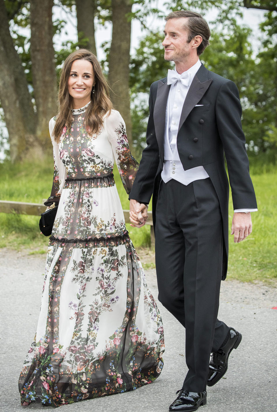 <p>These newlyweds made sure they were their best-dressed selves attending a friend's wedding in Stockholm a few weeks after their own nuptials. Pippa wore a white dress by Erdem with a pretty floral print - super pretty, but is white ever appropriate to a wedding? We're split on this one!</p>