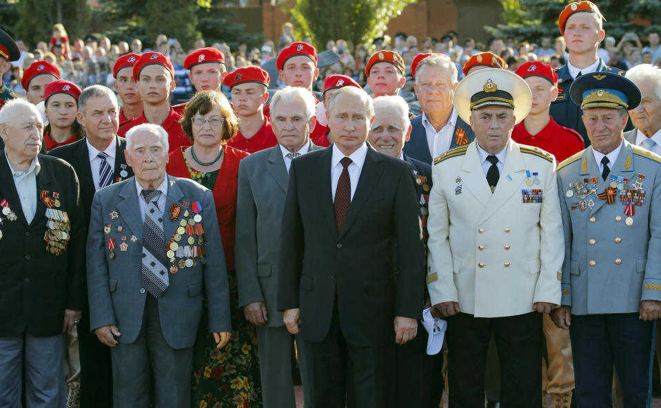 Russian President Vladimir Putin, center, stands among Russian WWII veterans during a laying ceremony in Kursk, 426 kilometers (266 miles) south of Moscow, Russia, Thursday, Aug. 23, 2018. Putin attends a ceremony marking the 75th anniversary of the battle of Kursk in which the Soviet army routed Nazi troops. It is described by historians as the largest tank battle in history involving thousands of tanks. (AP Photo/Alexander Zemlianichenko, Pool)