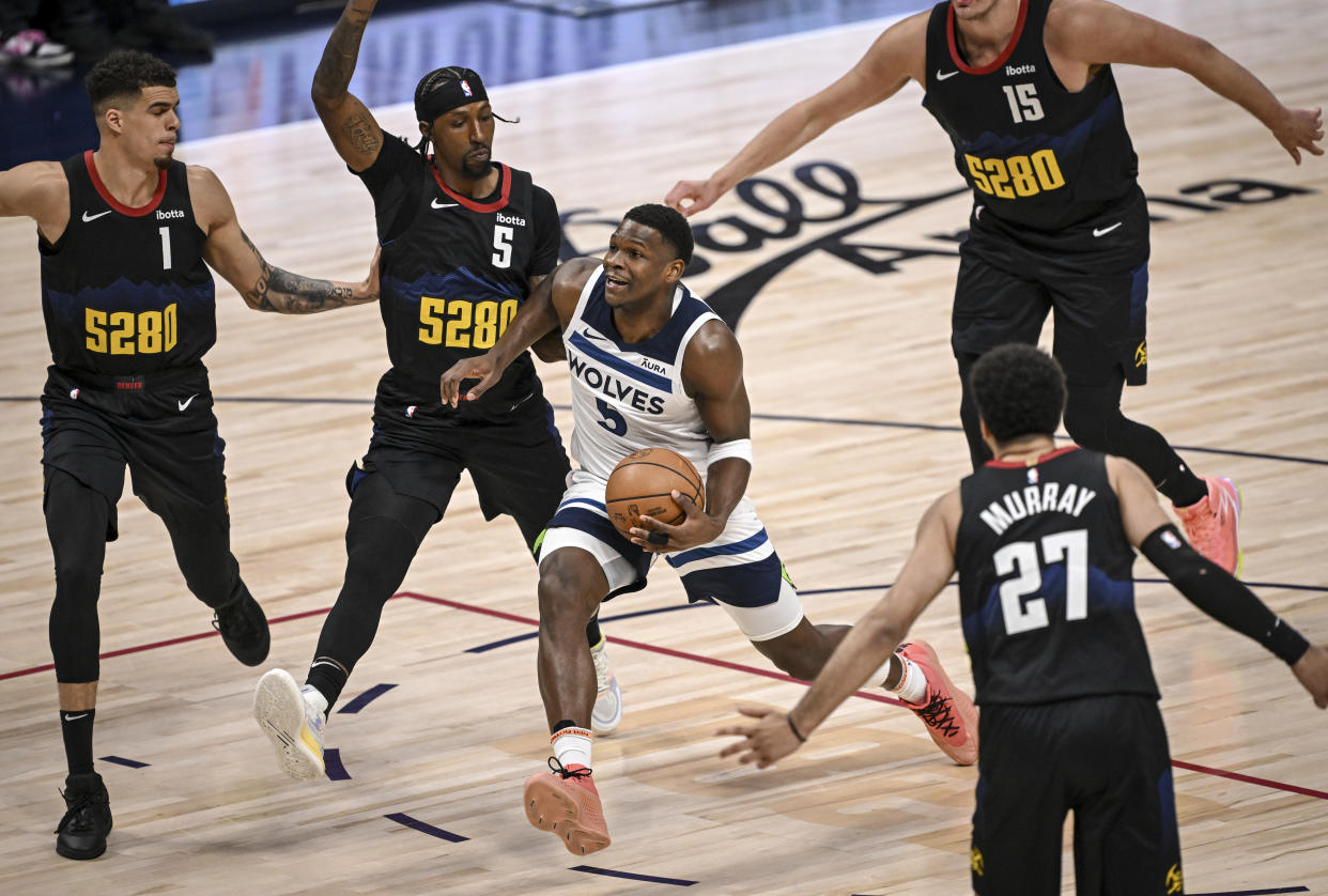 DENVER, CO - MAY 6: Anthony Edwards (5) of the Minnesota Timberwolves drives between Michael Porter Jr. (1), Kentavious Caldwell-Pope (5), Jamal Murray (27) and Nikola Jokic (15) of the Denver Nuggets during the first quarter at Ball Arena in Denver on Monday, May 6, 2024. (Photo by AAron Ontiveroz/The Denver Post)