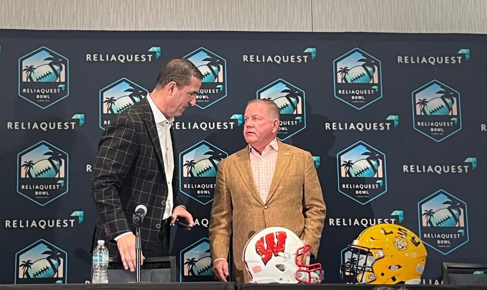 Wisconsin head coach Luke Fickell, left, talks with LSU head coach Brian Kelly at a news conference Friday ahead of Monday's ReliaQuest Bowl.