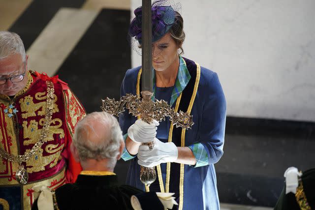 <p>PETER BYRNE/POOL/AFP via Getty </p> Katherine Grainger presents King Charles with the Elizabeth Sword at the coronation celebration on July 5.