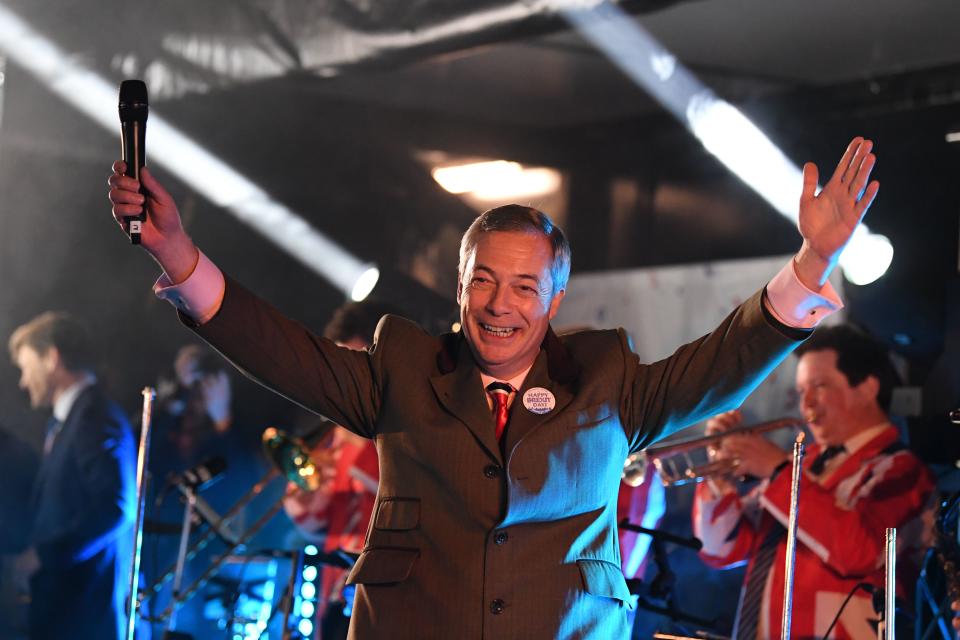 Brexit Party leader Nigel Farage gestures to the crowd from the stage in Parliament Square after addressing thousands at the Leave Means Leave party. (Getty)