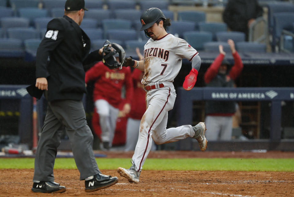 Arizona Diamondbacks' Corbin Carroll (7) scores a run against the New York Yankees during the seventh inning of a baseball game, Monday, Sept. 25, 2023, in New York. (AP Photo/Noah K. Murray)