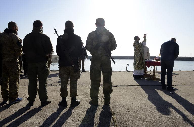 Ukrainian soldiers with the St Maria battalion attend a prayer service near the eastern city of Mariupol, on October 12, 2014