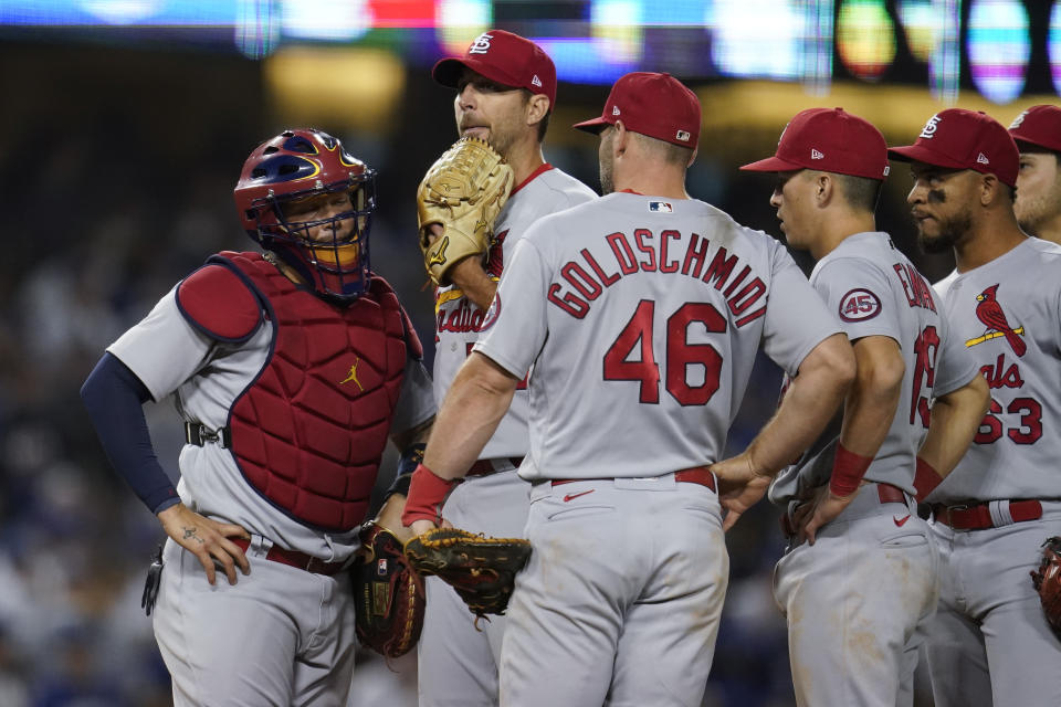 St. Louis Cardinals starting pitcher Adam Wainwright, second from left, leaves the game during the sixth inning of a National League Wild Card playoff baseball game against the Los Angeles Dodgers Wednesday, Oct. 6, 2021, in Los Angeles. (AP Photo/Marcio Jose Sanchez)
