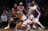 New York Knicks guard Immanuel Quickley, center, and Brooklyn Nets guard James Harden (13) fight for a loose ball during the second half of an NBA basketball game, Tuesday, Nov. 30, 2021, in New York. The Nets won 112-110. (AP Photo/Mary Altaffer)