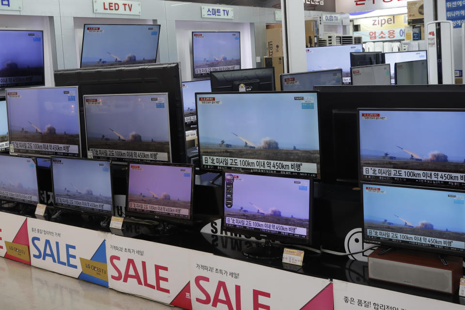 TV screens show a news program reporting about North Korea's missiles with file footage at an electronic shop in Seoul, South Korea, Thursday, March 25, 2021. North Korea on Thursday test-fired its first ballistic missiles since President Joe Biden took office, as it expands its military capabilities and increases pressure on Washington while nuclear negotiations remain stalled. The Korean letters on TVs read: "Japan, North missile flew about 450 kilometers." (AP Photo/Lee Jin-man)