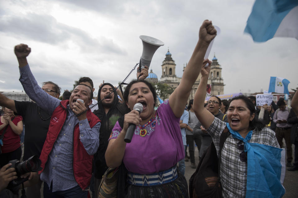 People protest against a decision by Guatemala's President Jimmy Morales to shut down the United Nations International Commission Against Impunity, CICIG, at Constitution Square in Guatemala City, Friday, Aug. 31, 2018. Last week the Supreme Court allowed a request brought by the CICIG and Guatemalan prosecutors to strip Morales' immunity from prosecution to go to Congress for consideration. (AP Photo/Oliver de Ros)