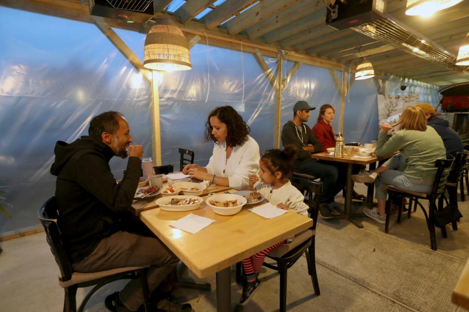 Ravindra Kharmai, his wife, Houneida, and their daughter Maya 3, enjoy dinner at Saffron De Twah in Detroit Saturday, April 30, 2022 the restaurant specializes in modern Moroccan food.
