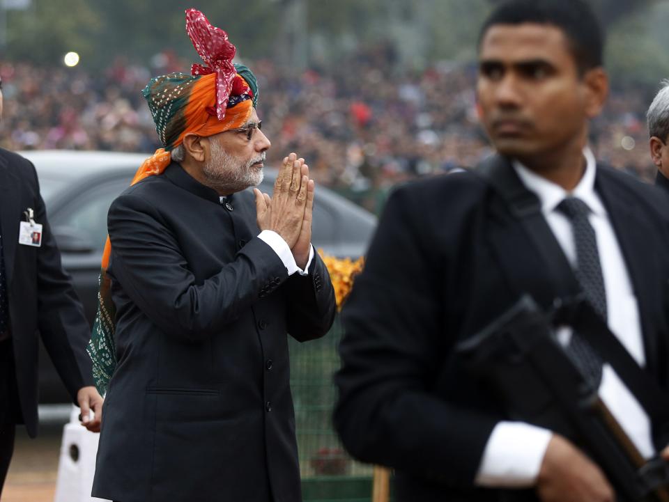 Prime Minister Narendra Modi gestures to the crowd as he arrives at the Republic Day parade in New Delhi