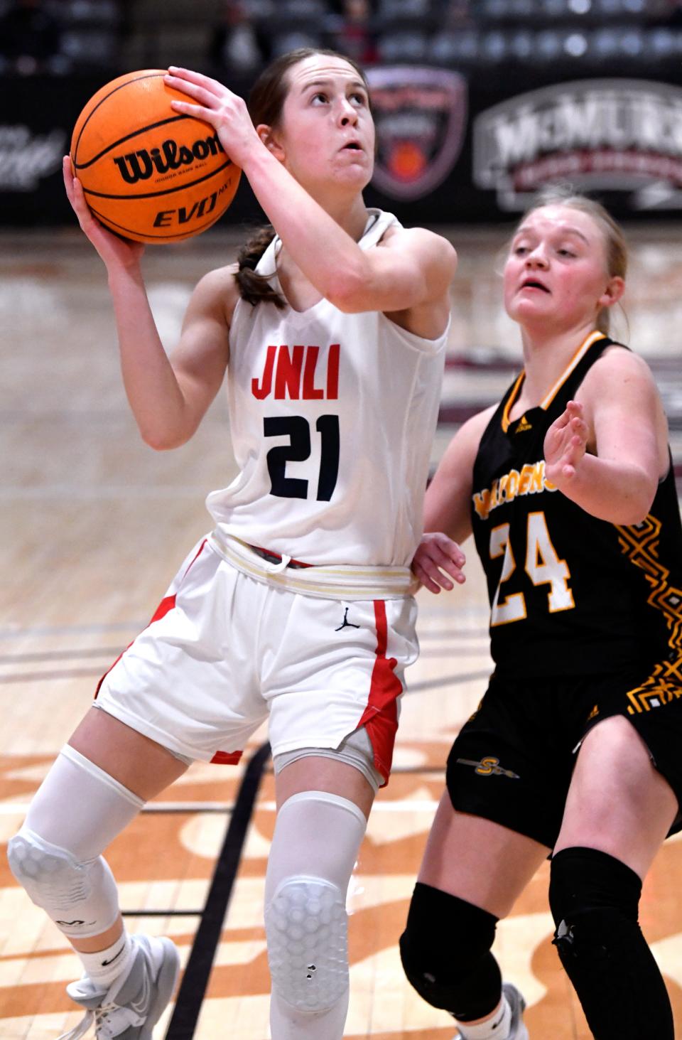 Jim Ned guard Riley Grohman takes the shot as Seminole's Olivia Hicks covers during the championship game of the Pug Parris Classic Nov. 19 at McMurry's Kimbrell Arena.