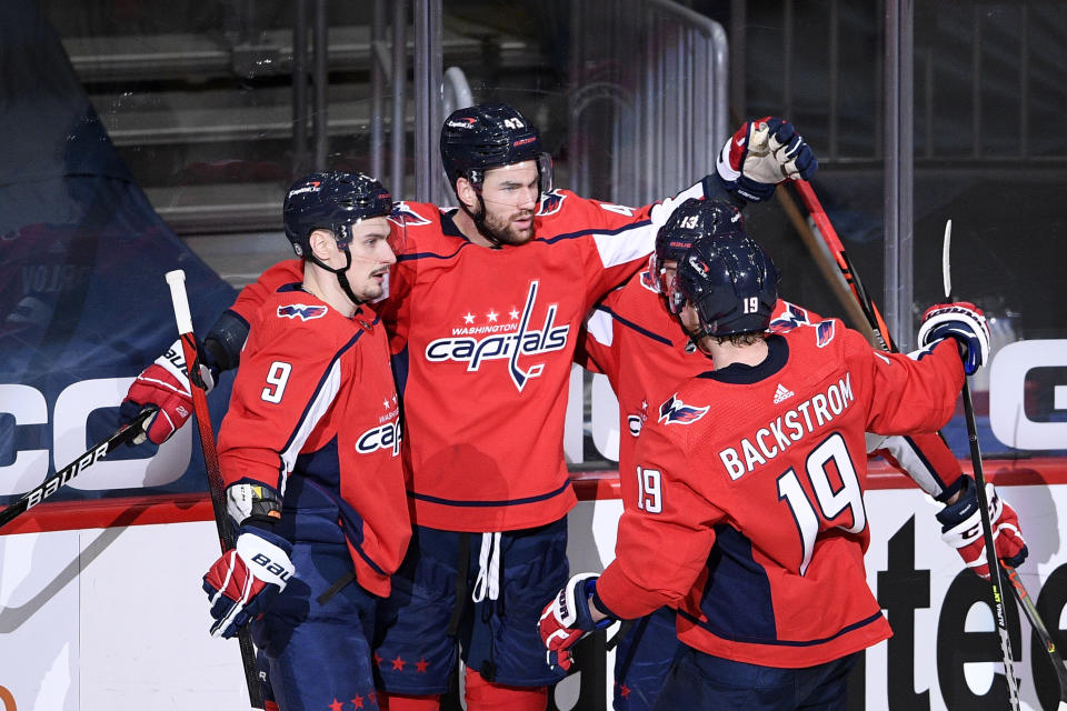 Washington Capitals right wing Tom Wilson (43) celebrates his first goal of the game with defenseman Dmitry Orlov (9) and center Nicklas Backstrom (19) during the second period of an NHL hockey game against the New York Rangers, Sunday, March 28, 2021, in Washington. (AP Photo/Nick Wass)