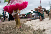 <p>A young girl wearing wellington boots plays with sand with a young boy at Glastonbury Festival Site on Worthy Farm in Pilton on June 23, 2017 near Glastonbury, England. (Photo: Chris J Ratcliffe/Getty Images) </p>