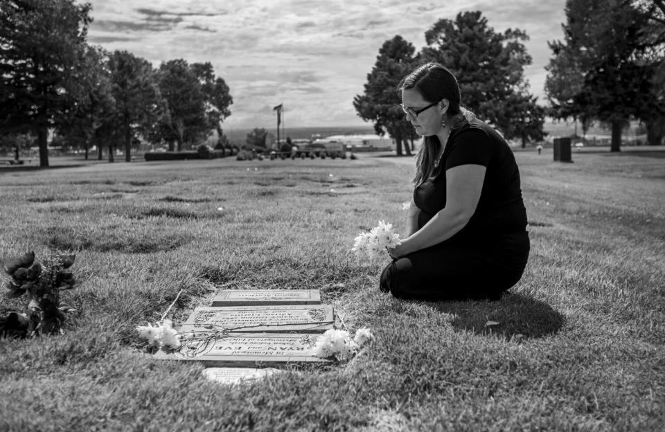 Tara Shaver, a local antiabortion missionary, kneels at the graves of fetal remains at Baby Land.