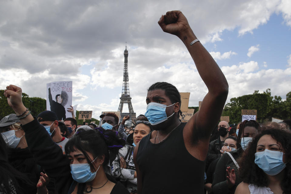 Hundreds of demonstrators gather on the Champs de Mars as the Eiffel Tower is seen in the background during a demonstration in Paris, France, Saturday, June 6, 2020, to protest against the recent killing of George Floyd, a black man who died in police custody in Minneapolis, U.S.A., after being restrained by police officers on May 25, 2020. Further protests are planned over the weekend in European cities, some defying restrictions imposed by authorities because of the coronavirus pandemic. (AP Photo/Francois Mori)