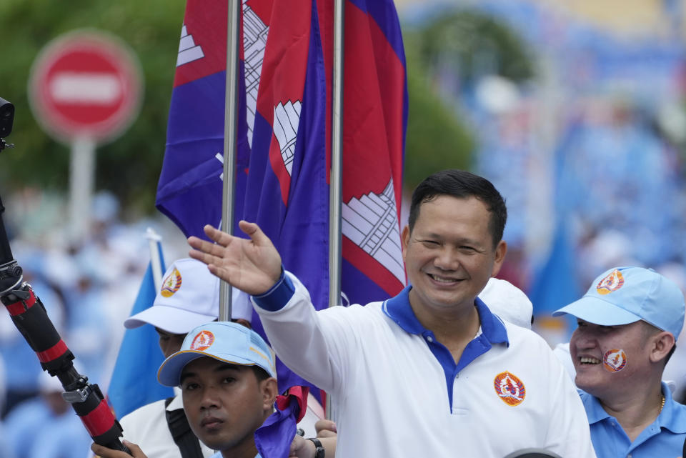 Hun Manet, foreground, a son of Cambodia Prime Minister Hun Sen, waves his supporters as he leads a procession to mark the end of an election campaign of Cambodian People's Party, in Phnom Penh, Cambodia, on July 21, 2023. Cambodian King Norodom Sihamoni on Monday, Aug. 7, formally endorsed army chief Hun Manet to succeed his father and long-ruling Prime Minister Hun Sen as the nation's leader later this month after their party sealed victory in a one-sided election last month. (AP Photo/Heng Sinith)