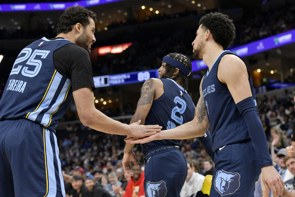 Memphis Grizzlies forward Maozinha Pereira (25), guard Zavier Simpson (2) and guard Scotty Pippen Jr., right, react in the second half of an NBA basketball game against the Detroit Pistons, Friday, April 5, 2024, in Memphis, Tenn. (AP Photo/Brandon Dill)