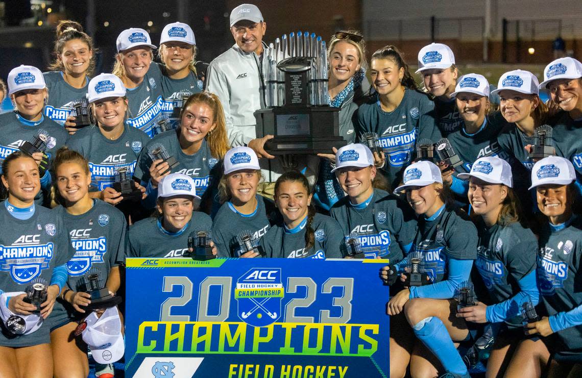 North Carolina field hockey coach Erin Matson accepts the ACC Championship trophy from commissioner Jim Phillips following the Tar Heels’ 2-0 victory against Duke on Friday, November 3, 2023 in Charlottesville, Va. The Tar Heels claimed their seventh consecutive ACC Championship, and the first for Matson as head coach.