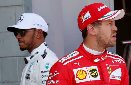 FILE PHOTO: Formula One - F1 - Spanish Grand Prix - Barcelona-Catalunya racetrack, Montmelo Spain - 13/05/17 - Mercedes' Lewis Hamilton and Ferrari's Sebastian Vettel after the qualifying session. REUTERS/Albert Gea/File Photo