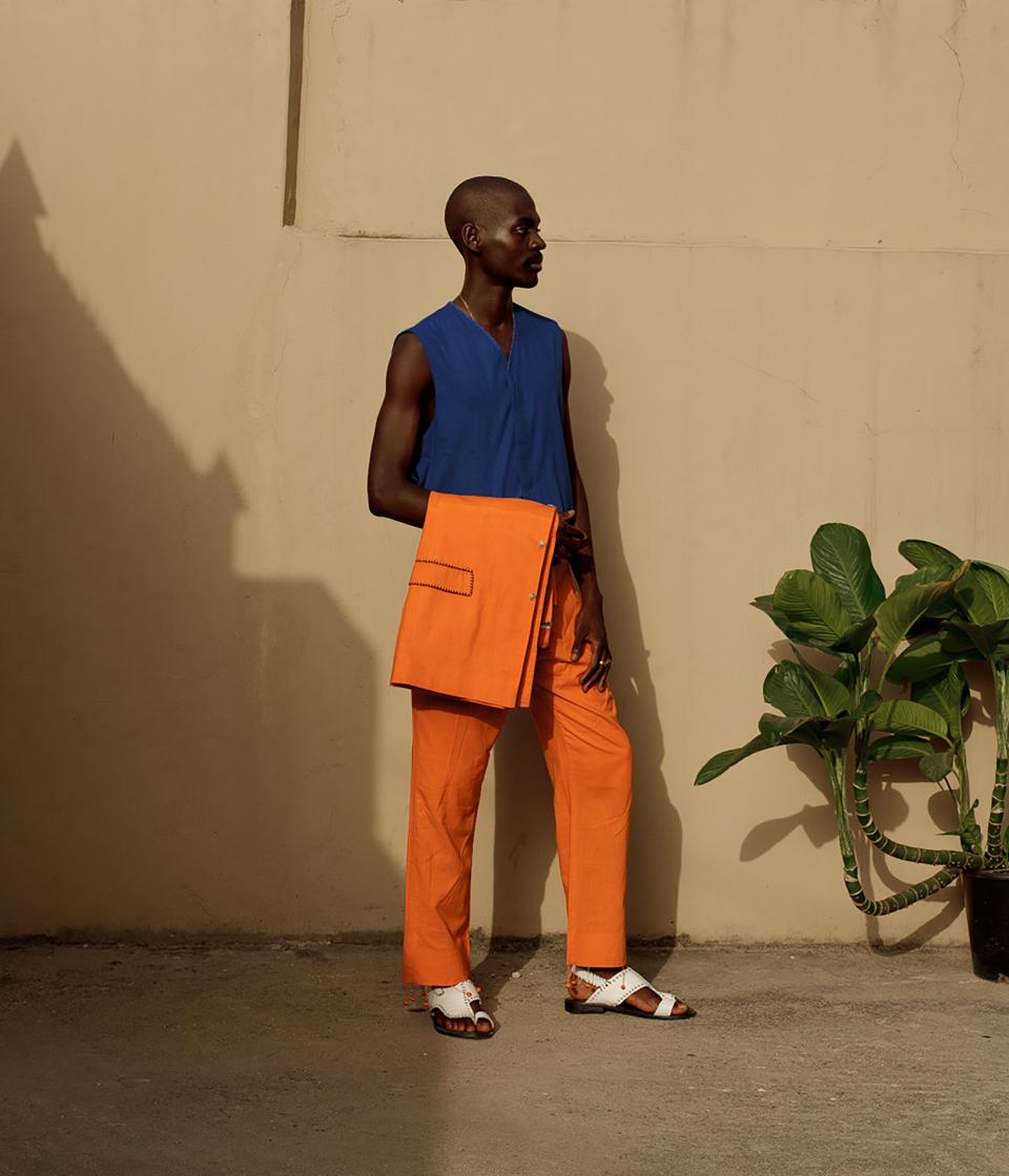 The 24-year-old multi-hyphenate pairs custom-tailored prints with bold African accessories.