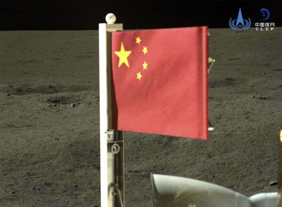 En esta imagen proporcionada por la Administración Espacial Nacional China (CNSA), publicada por la agencia de noticias Xinhua, una bandera nacional china transportada por el módulo de aterrizaje de la Chang'e-6 se despliega en la cara oculta de la Luna, el martes 4 de junio de 2024. China dice que una nave con muestras de roca y tierra despegó de la cara oculta de la Luna para iniciar su camino de regreso a la Tierra. (CNSA/Xinhua via AP)