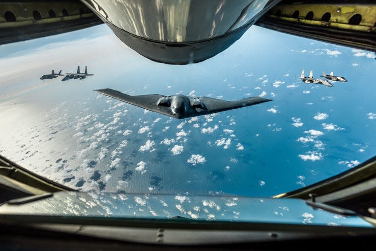 An Air Force B-2 Spirit bomber, two Royal Air Force F-35 Lightning IIs and two F-15 Eagles fly in formation behind a KC-135 Stratotanker during a training mission over England, Sept. 16, 2019.