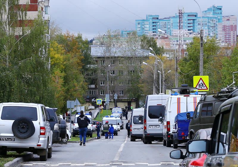 Police and members of emergency services work near the scene of a school shooting in Izhevsk