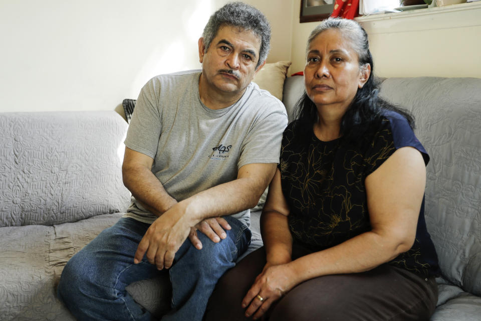 In this Thursday, June 4, 2020, photo, Francisco Flores, left, poses for a portrait with his wife Livia Herrera in New York. When his brother Crescencio Flores died of coronavirus in New York, his parents back in Mexico asked for one thing: that their son be sent home for burial. So far, his efforts have been in vain. “I am trying to do this because my parents, 85 and 87 years old, live there," Francisco Flores said. “They are rooted in their customs. They want a Christian burial for the remains of their son.” (AP Photo/Frank Franklin II)