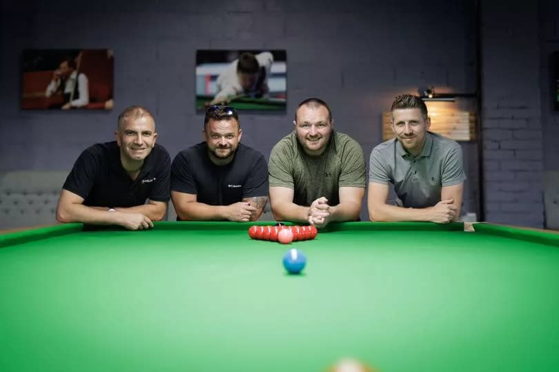 four men at end of snooker table