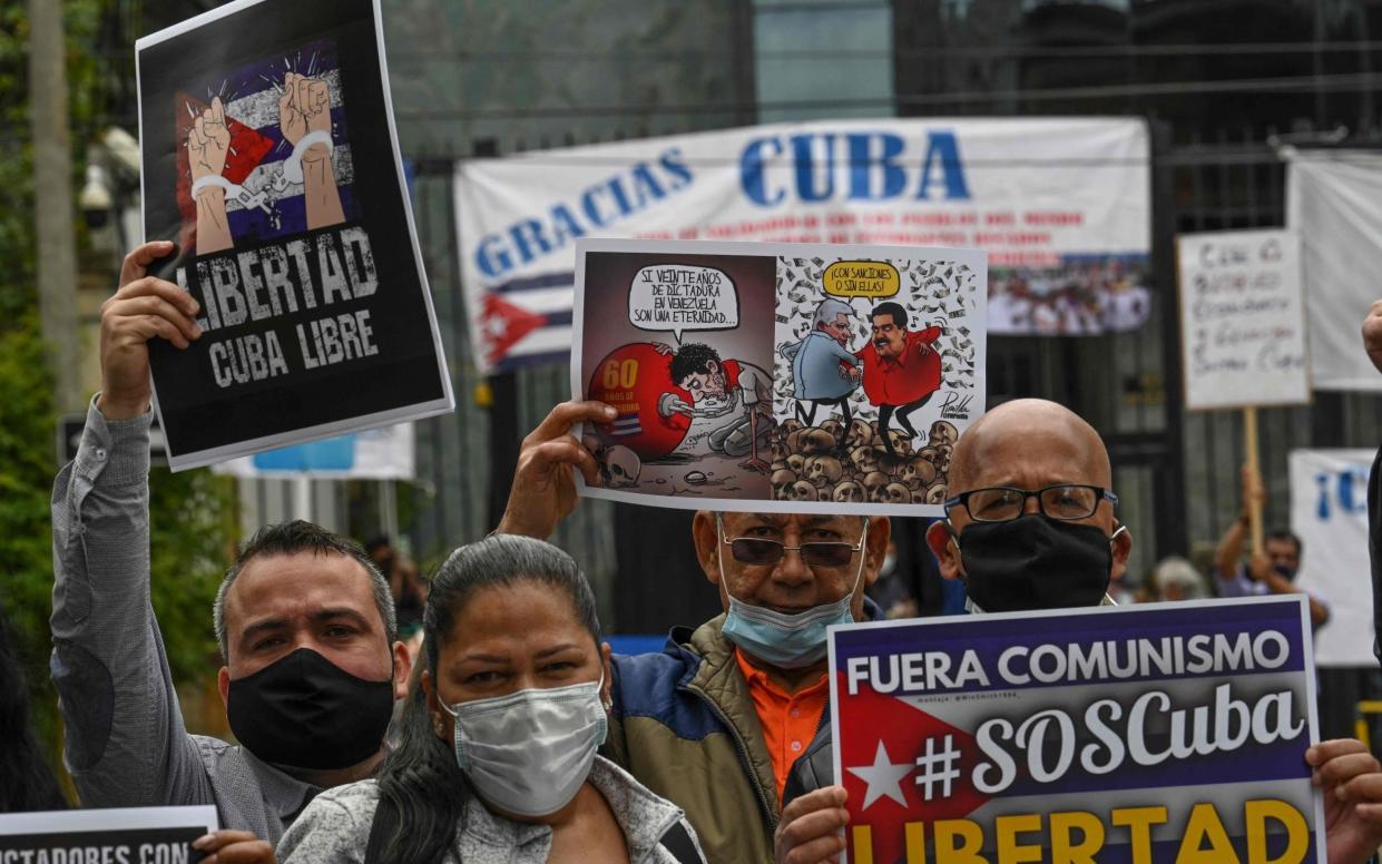 Venezuelan citizens residing in Colombia during a demonstration against the government of Cuban President Miguel Diaz-Canel, outside the Cuban Embassy in Bogota - AFP