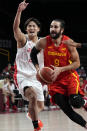 Spain's Ricky Rubio (9) drives past Japan's Daiki Tanaka (24) during a men's basketball preliminary round game at the 2020 Summer Olympics in Saitama, Japan, Monday, July 26, 2021. (AP Photo/Eric Gay)