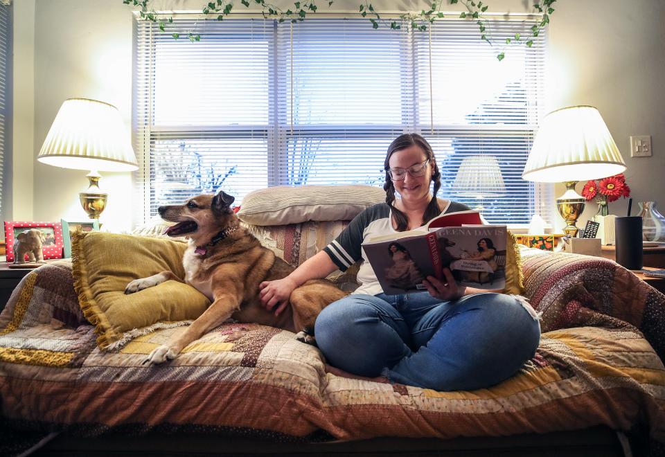 Mary Mour reads a book by Geena Davis at her home in Sellersburg along with one of her dogs, Che Guevara. Mour is a therapist who needs her own therapist. But she's been waiting for a year and a half because of long waitlist for counselors that can help her. In the meantime, she likes being outside and reading as self care. November 16, 2023
