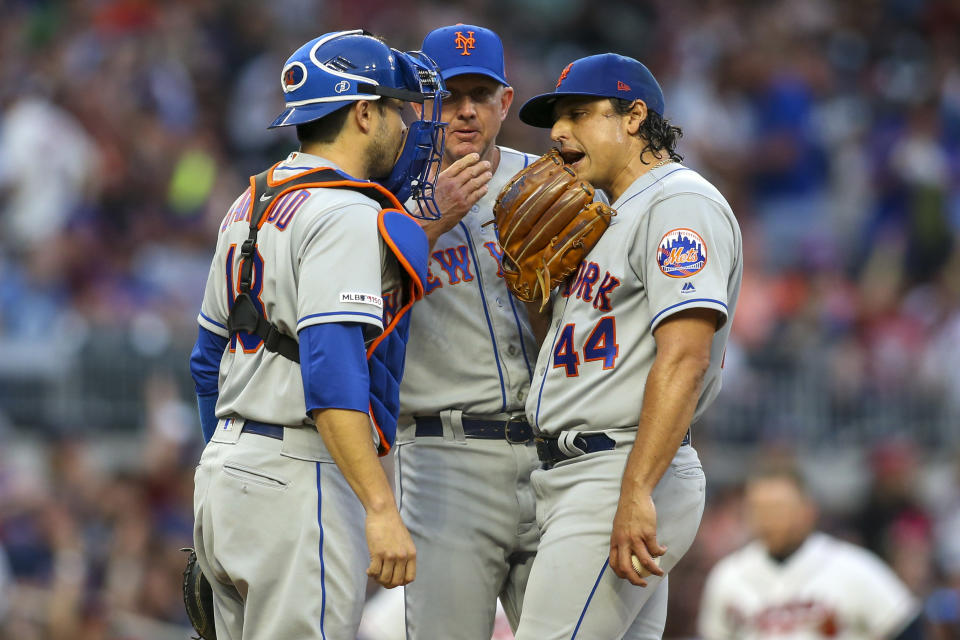 Apr 13, 2019; Atlanta, GA, USA; New York Mets catcher Travis d'Arnaud (18) and pitching coach Dave Eiland (58) and starting pitcher Jason Vargas (44) talk on the mound against the Atlanta Braves in the first inning at SunTrust Park. Mandatory Credit: Brett Davis-USA TODAY Sports