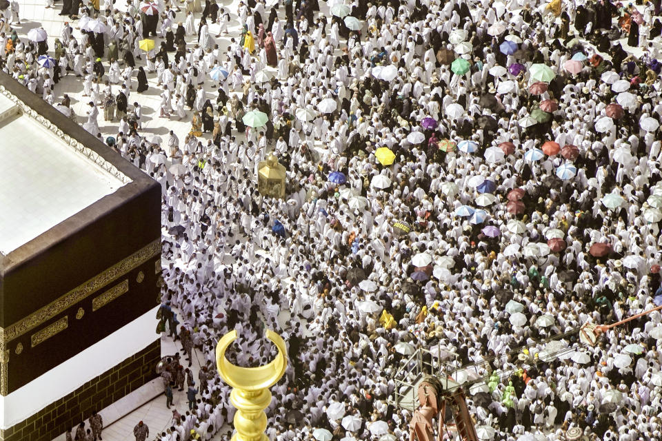 Thousands of Muslim pilgrims hold umbrellas as they circumambulate around the Kaaba, the cubic building at the Grand Mosque, during the annual hajj pilgrimage, in Mecca, Saudi Arabia, Sunday, June 25, 2023. Muslim pilgrims are converging on Saudi Arabia's holy city of Mecca for the largest Hajj since the coronavirus pandemic severely curtailed access to one of Islam's five pillars. (AP Photo/Amr Nabil)