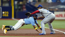 Tampa Bay Rays' Manuel Margot dives back safely ahead of the pickoff throw to Toronto Blue Jays first baseman Vladimir Guerrero Jr. during the first inning of a baseball game Thursday, Sept. 22, 2022, in St. Petersburg, Fla. (AP Photo/Chris O'Meara)
