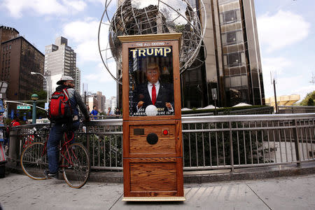 A Donald Trump themed fortune telling machine stands on the street in Columbus Circle in New York, U.S., October 12, 2016. REUTERS/Lucas Jackson