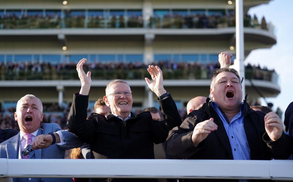 Racegoers celebrate as Honeysuckle ridden by jockey Rachael Blackmore (not pictured) win the Close Brothers Mares' Hurdle on day one of the Cheltenham Festival at Cheltenham Racecourse - PA/Tim Goode