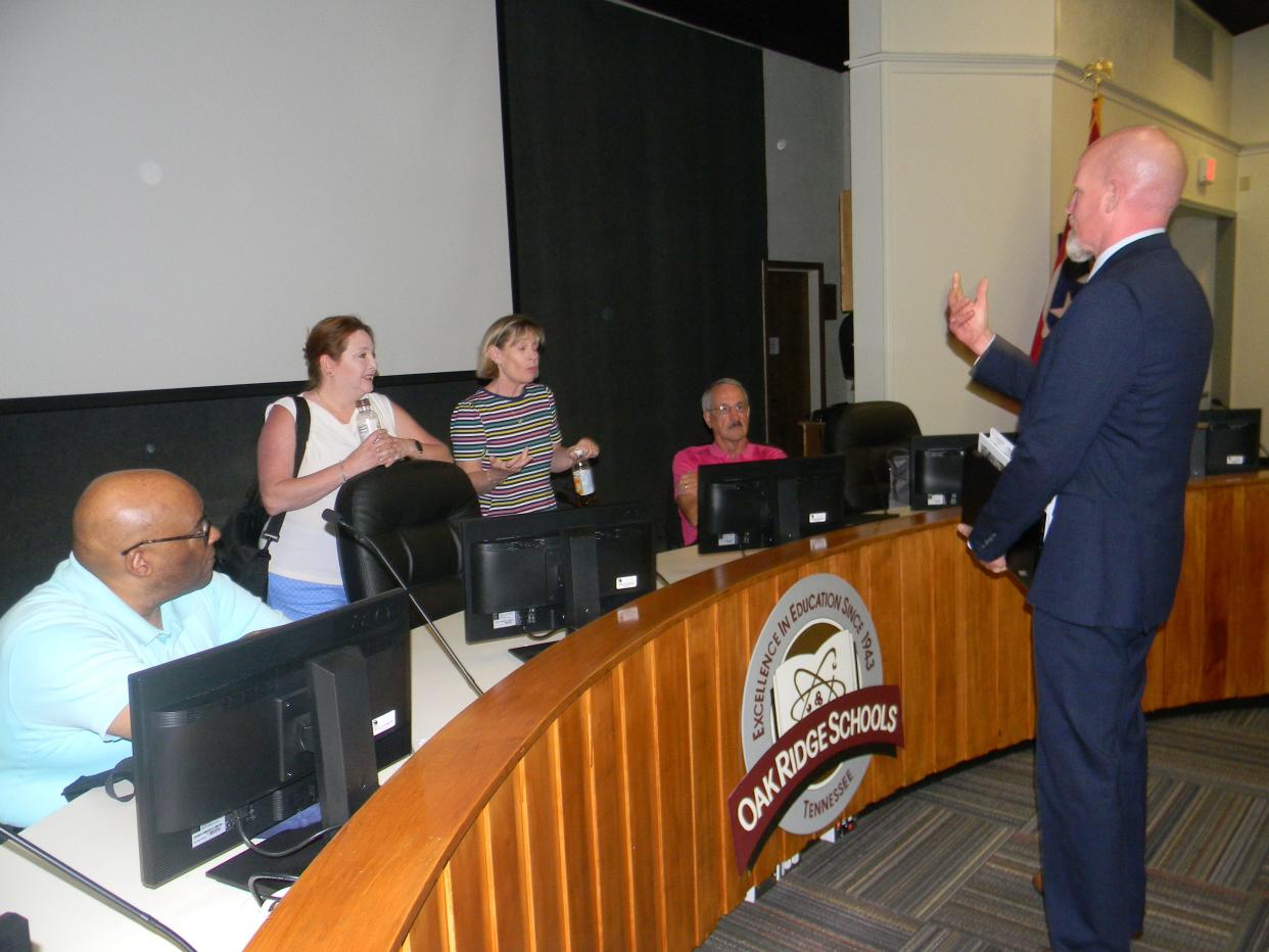 Oak Ridge Schools Superintendent Bruce Borchers talks to Oak Ridge Board of Education members after a meeting. Pictured are Benjamin Stephens, from left, Angi Agle, Vice Chairwoman Laura McLean and Chairman Keys Fillauer.