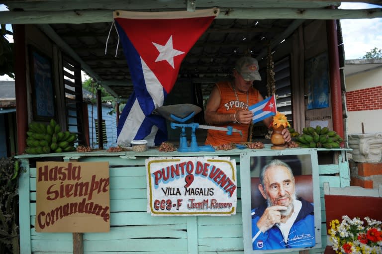 A farmer decorates his stall as he waits for the urn with the ashes of Cuban leader Fidel Castro to be driven through the streets of Las Tunas