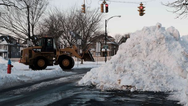 PHOTO: An excavator piles up snow on the east side of Buffalo, New York, Dec. 29, 2022. (Joed Viera/AFP via Getty Images)