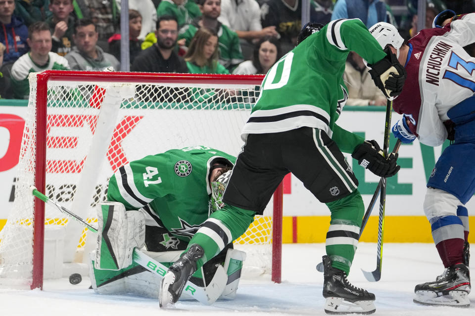 A shot by Colorado Avalanche's Nathan MacKinnon, not visible, gets by Dallas Stars goaltender Scott Wedgewood (41) for a goal during the first period of an NHL hockey game, Thursday, Jan. 4, 2024 in Dallas. Avalanche right wing Valeri Nichushkin (13) helps attack against Stars defenseman Ryan Suter (20) on the play. (AP Photo/Julio Cortez)