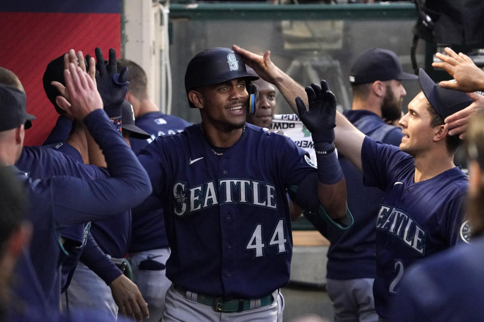 Seattle Mariners' Julio Rodriguez is congratulated by teammates in the dugout after hitting a solo home run during the fourth inning of a baseball game against the Los Angeles Angels Friday, June 24, 2022, in Anaheim, Calif. (AP Photo/Mark J. Terrill)