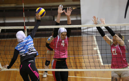 Iranian volleyball players Maedeh Borhani (C) and Zeinab Giveh (L) take part in a training session of "Shumen" volleyball club in Shumen, Bulgaria January 14, 2017. Picture taken on January 14, 2017. REUTERS/Stoyan Nenov