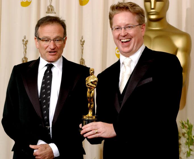 Robin Williams with Andrew Stanton, winner for Best Animated Feature for 'Finding Nemo' at the 76th Academy Awards in 2004.