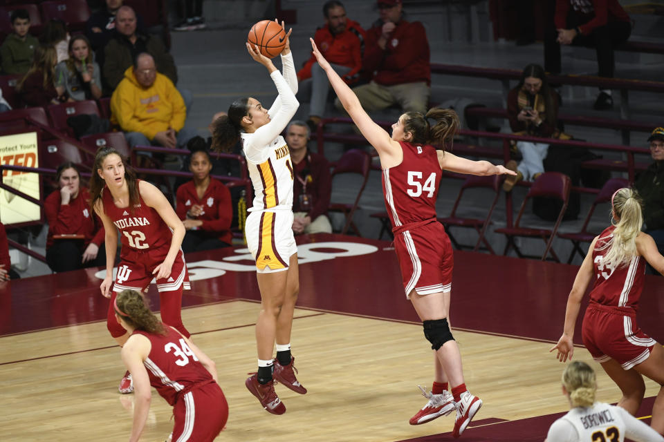 Minnesota guard Angelina Hammond, center, takes a shot over Indiana forward Mackenzie Holmes (54) during the first half of an NCAA college basketball game on Wednesday, Feb 1, 2023, in Minneapolis. (AP Photo/Craig Lassig)