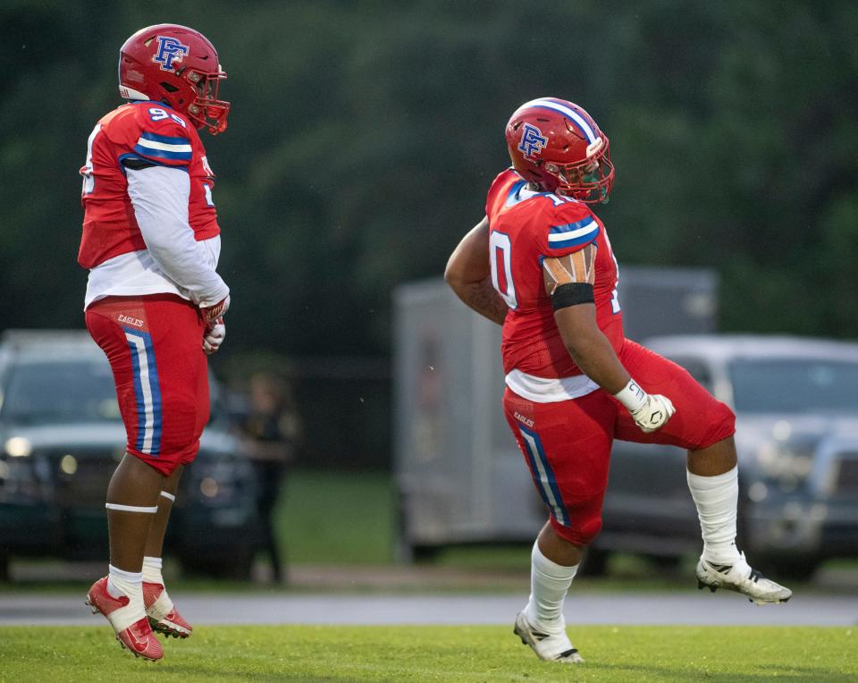 Rocsavian McWilliams (99) and Elijah Douglas (10) celebrate a sack during the Tate vs Pine Forest football game at Pine Forest High School in Pensacola on Thursday, Aug. 25, 2022.