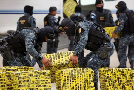 FILE PHOTO: Police officers carry packages containing cocaine seized during operations in Retalhuleu and San Marcos southwest of Guatemala City, after their arrival at the air force base in Guatemala City