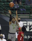 Baylor guard MaCio Teague (31) shoots a three-point basket over Texas Tech guard Kyler Edwards in the second half of an NCAA college basketball game Sunday, March 7, 2021, in Waco, Texas. (AP Photo/Jerry Larson)