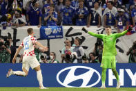 Croatia's Mario Pasalic, left, celebrates with teammate goalkeeper Dominik Livakovic after he scored his penalty kick during the World Cup round of 16 soccer match between Japan and Croatia at the Al Janoub Stadium in Al Wakrah, Qatar, Monday, Dec. 5, 2022. (AP Photo/Eugene Hoshiko)